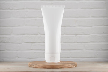 Mocap cosmetic tube is standing on a wooden stand on a background of a white brick wall. Cosmetic tube mockup for your design. 3d render.