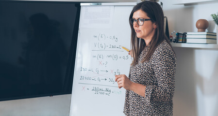 Teacher recording video tutorial for e-learning class.
Female professor standing and explaining the...