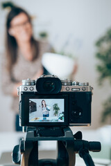 Smiling Business Woman Showing Handmade Pots.
Happy businesswoman having online presentation of modern clay flowerpot and using camera for live broadcast online on the internet.