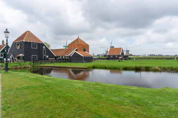 view of traditional 18th-century Dutch farmhouses and windmills in North Holland Province