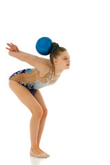 Girl gymnast performs exercises with the ball.