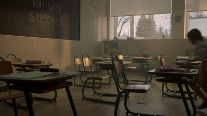 Students running in classroom for lesson. Multi ethnic pupils talking in class