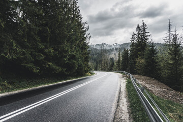 Fototapeta premium incredibly beautiful mountain road among the trees