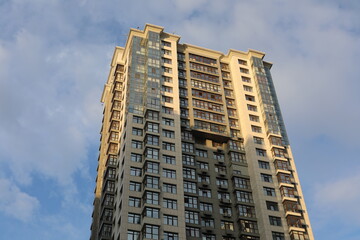 Fototapeta premium Scenic view of contemporary residential houses on a cloudy day. True modern cityscape of the Ukrainian capital. Design of contemporary build in big city. Real urban style of residential building.