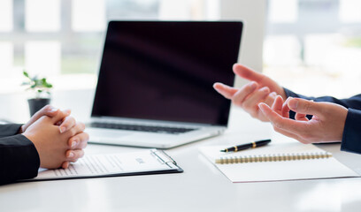 Male employer holding resume talking with female job candidate at interview, black millennial girl...