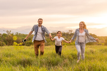 Young happy family in a field