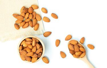Top view close up of healthy almonds in wooden bowl with isolate on white background.