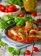 Delicious grilled fish with tomato sauce