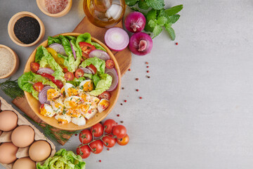Diet menu. Healthy salad of fresh vegetables - tomatoes, egg, Onion. high angle view of a nutritious vegetable salad with boiled egg slices, served.  Healthy meal concept.