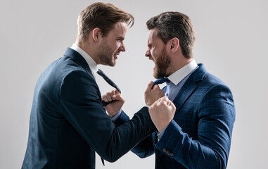 two angry businessmen punching in fight and arguing having struggle, aggressive negotiations.