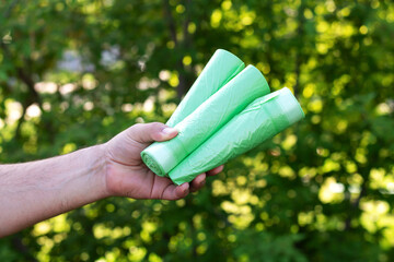 Holding eco plastic garbage bio bags in rolls