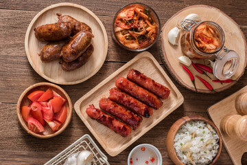 Flatlay of filipino sausage breakfast with longganisa, garlic rice, and korean kimchi