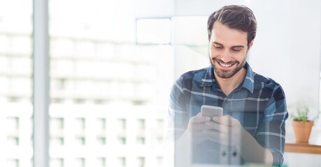 Composition of smiling man using smartphone in office with white overlay