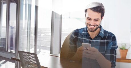Composition of smiling man using smartphone in office with white overlay
