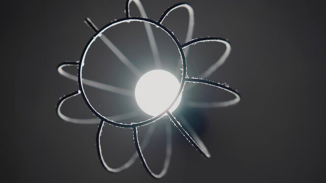 Close-up of a dusty metal lamp that hangs from the ceiling. Close - up shooting with rotation