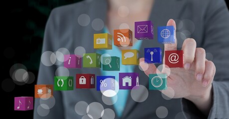 Composition of businesswoman touching screen with digital colouruful icons
