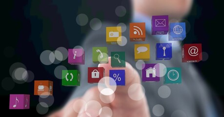 Composition of businessman touching screen with digital colourful icons