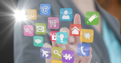 Composition of businesswoman touching screen with digital colourful icons