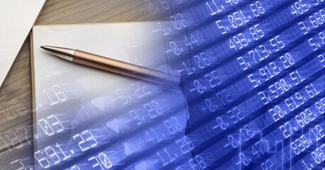 Composition of financial data processing and notebook with pen on blue background