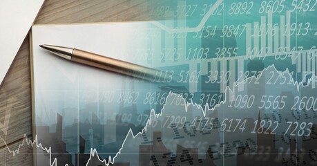 Composition of financial statistics processing and notepad with pen in background