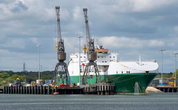 Marchwood, Southampton, England, UK. 2021.  Two cranes tower over the roro Hurst Point a military supplies ship at Marchwood, Southampton Water, England, UK.