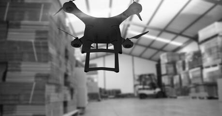 Drone flying over a warehouse in black and white, delivery and technology concepts