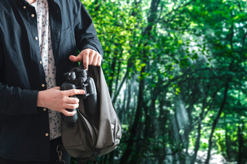 Fototapeta na wymiar person taking the binoculars from bag and adjusting it