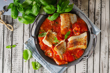 Delicious grilled fish with tomato sauce