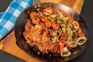 Meat, Pork neck in marinade and on a steel pan. Pork neck with baked potatoes and vegetables with chili.