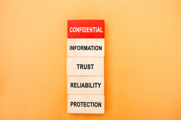 Naklejka premium Wooden blocks with the words Confidential Information, trust, reliability, protection. Non-public oral or written business information. Undisclosed. Commercial secrets. Own. Property