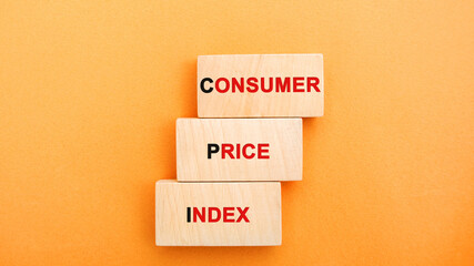 Wooden blocks with the words Consumer price index. Measuring the average level of change in prices...