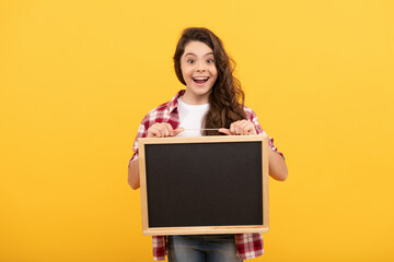 surprised child hold school blackboard for copy space, announcement