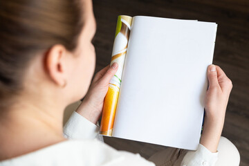 Female hands open blank catalog, magazines, book mock up