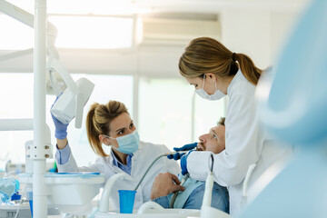 Man having teeth examined at dentists.