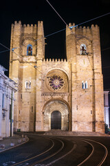 Lisbon Cathedral illuminated at night in the Alfama district, Portugal