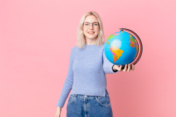 blond pretty woman holding a worl globe map