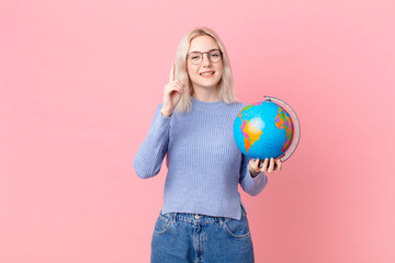 blond pretty woman holding a worl globe map