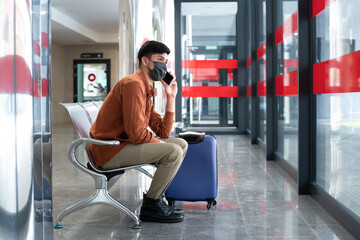 Fototapeta premium Man sitting at station talking on mobile phone