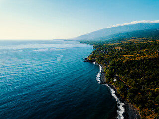 Aerial drone view of the beautiful black sandy beach in Bali, Indonesia