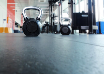 Obraz na płótnie Canvas Focus on black kettlebell at the gym