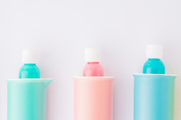 Colored bowl and jar, pantone, colored items diplayed on a white background, egg carrier, and different color paint on plastic container,   top view, flatlay, wallpaper type advertisement style.