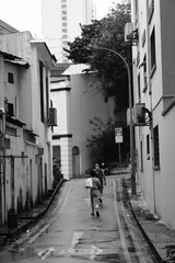 two people walking in a narrow street