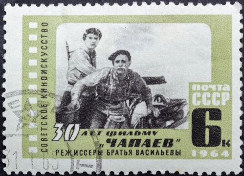 Postage stamp 'Shot from the film 'Chapaev' directors - brothers Vasiliev' printed in USSR. Series: '30th anniversary of the movie 'Chapaev'' by artist E. Beketov, 1964