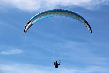 Paraglider in a blue sky	