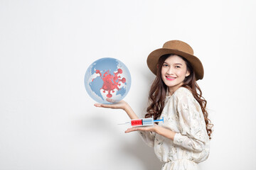 Fototapeta premium Young asian woman smiling holding a syringe with liquid vaccines, Concept fight against virus covid-19 corona virus, Conceptdiseases,medical care,science.