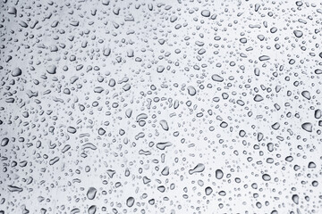 Many different drops of water on the metal surface