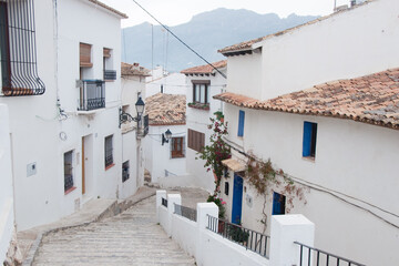 Fototapeta na wymiar Beautiful street at Altea with white houses, blue doors and windows and no people.Spain