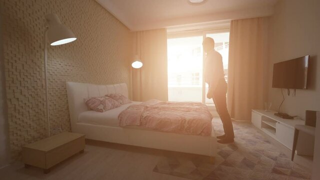 Tired man falling on the bed in slow motion 180fps