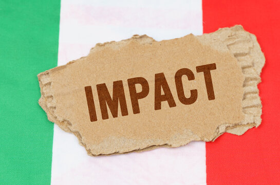 Against the background of the flag of Italy lies cardboard with the inscription - impact - Powered by Adobe