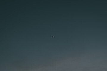 Waxing crescent moon in middle of beautiful dark sky - obrazy, fototapety, plakaty